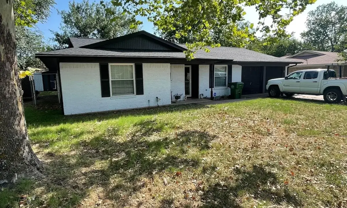Professional roofing crew working on a residential roof in Hermon